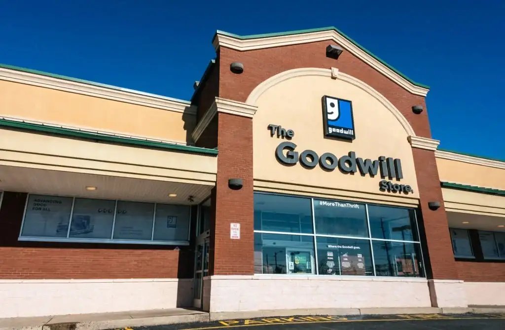 Exterior view of a Goodwill store entrance on a sunny day.