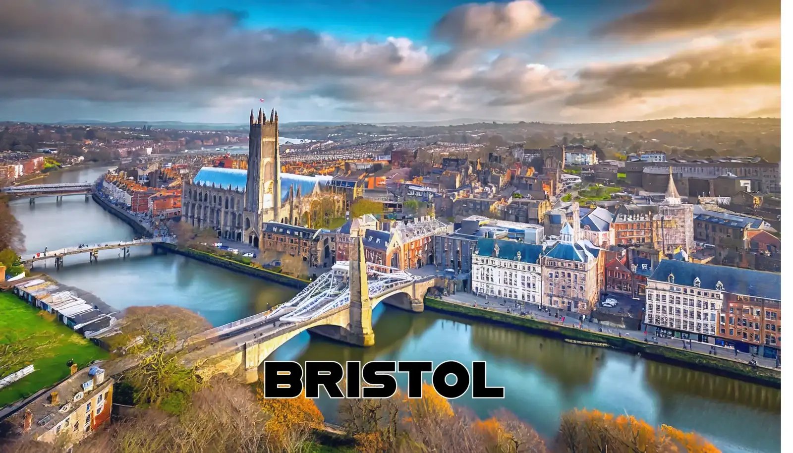 Aerial view of Bristol cityscape with historic buildings and a bridge over the river.